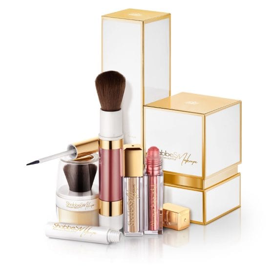 Diverse cosmetics and their elegant packaging in white gold hues on white in white background product photography