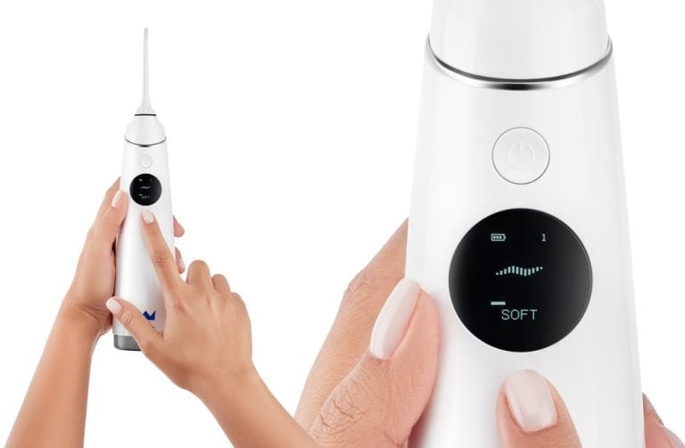 Irrigator in hands on white background closeup on its screen in product photography on white background